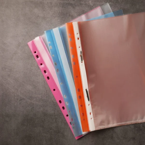 File folders with punched pockets on grey table, flat lay. Space for text
